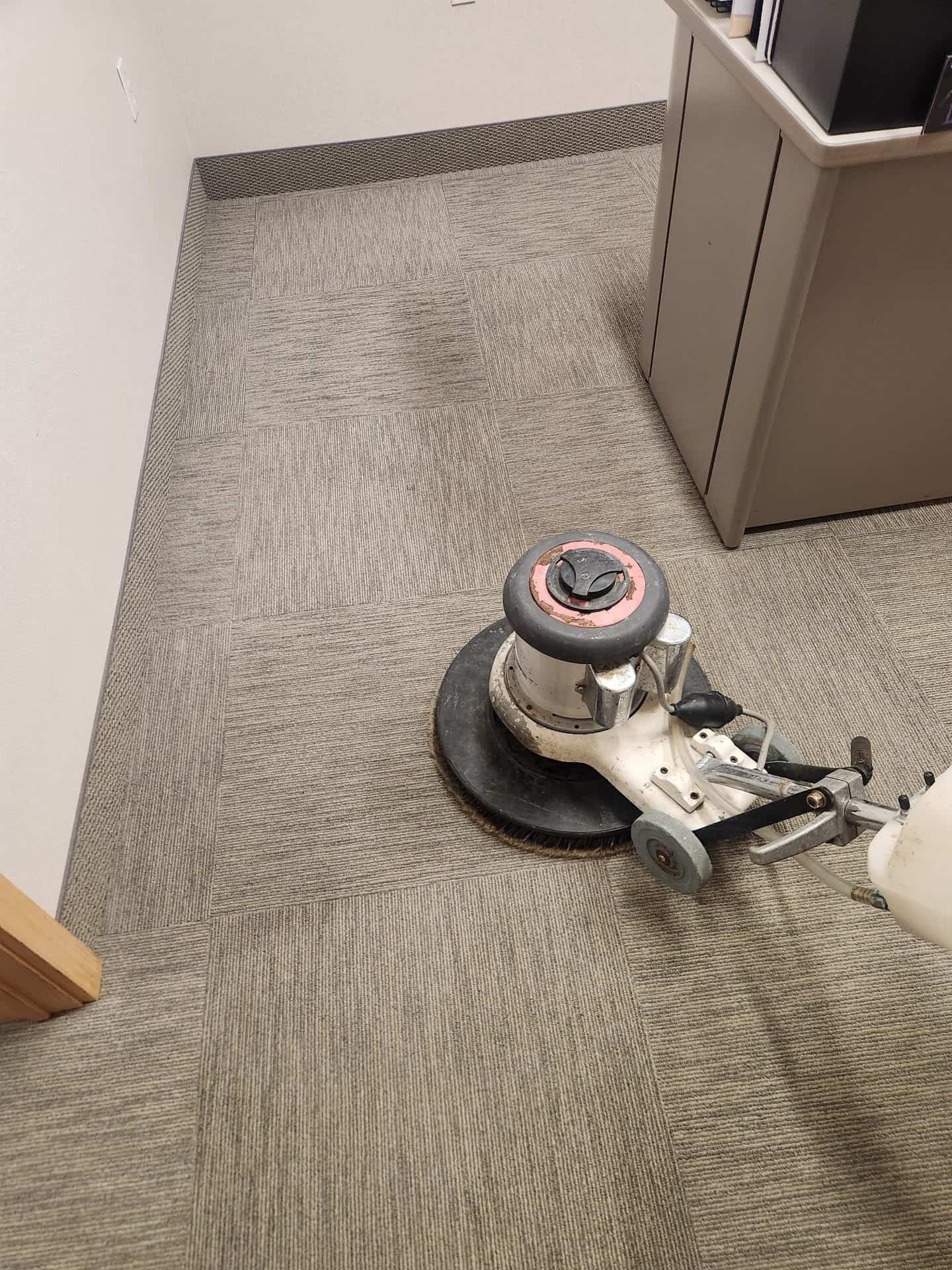 Professional carpet cleaning equipment used on commercial carpet in an insurance office
