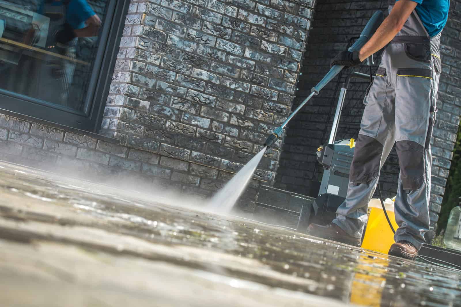 Workers washing a residential driveway